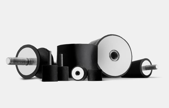 Selection of anti-vibration mounts and silent blocks in black rubber with threaded studs and holes on a white background